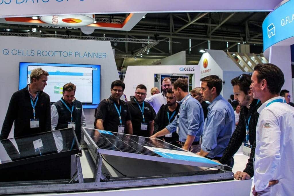 A group of people looking at a solar panel.