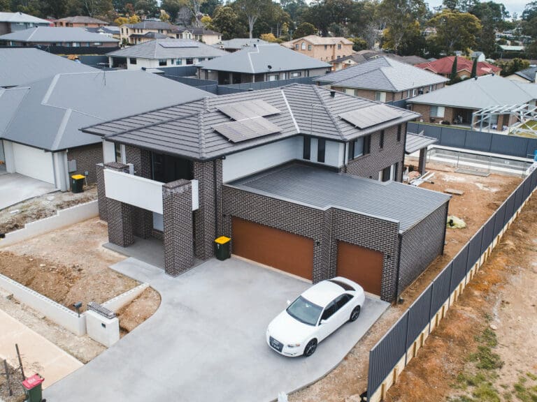 An aerial view of a house with a car parked in front of it.