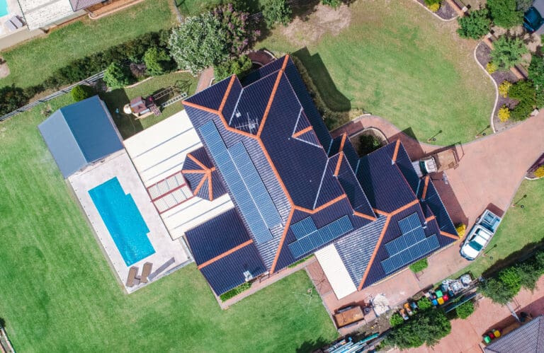 An aerial view of a house with a swimming pool.