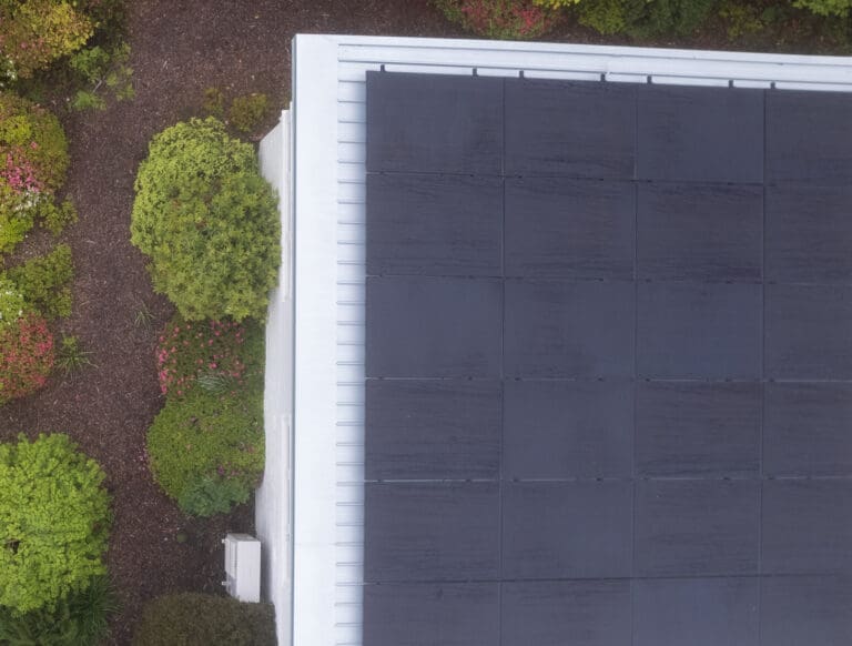 An aerial view of a solar panel on a roof.