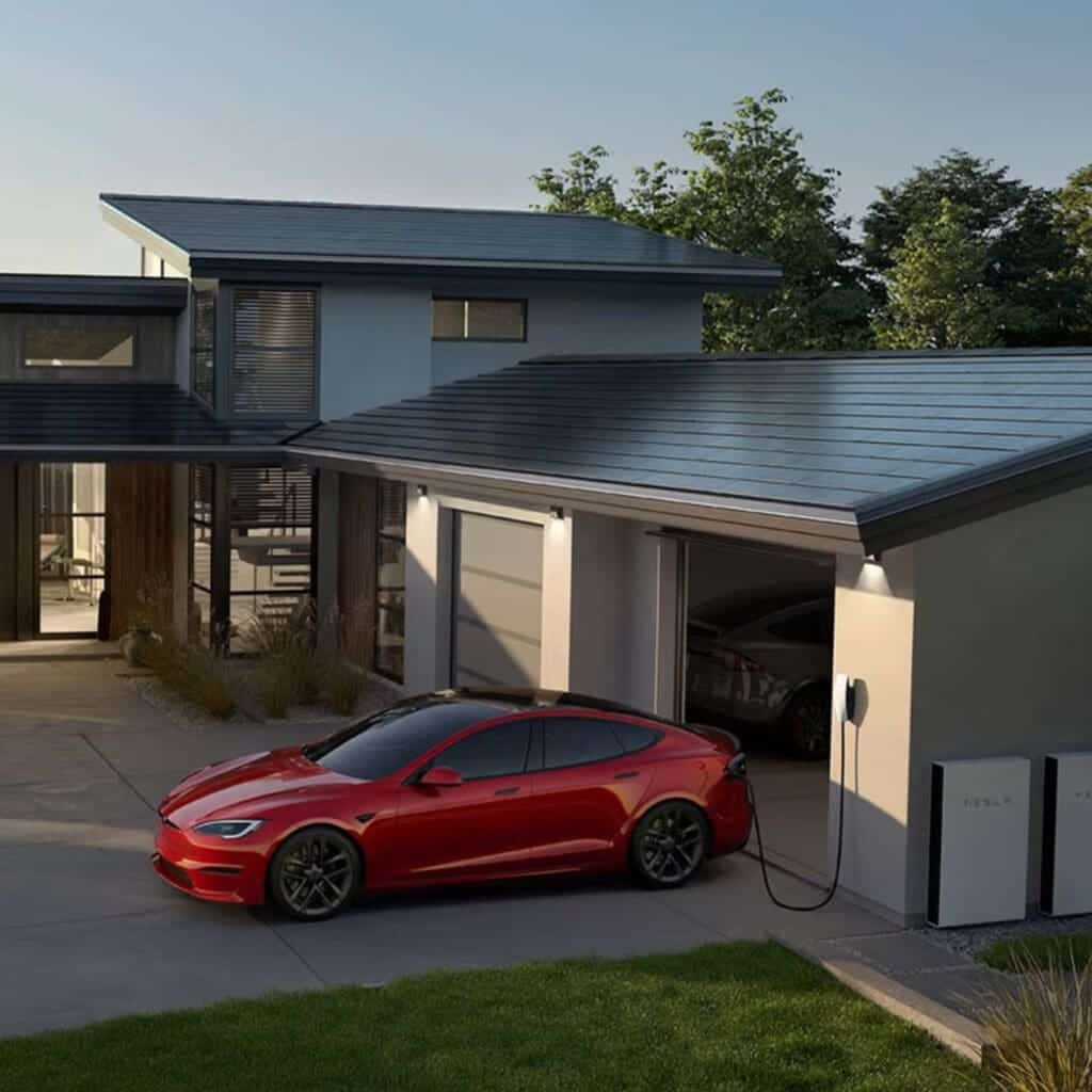 A tesla model s parked in front of a house.