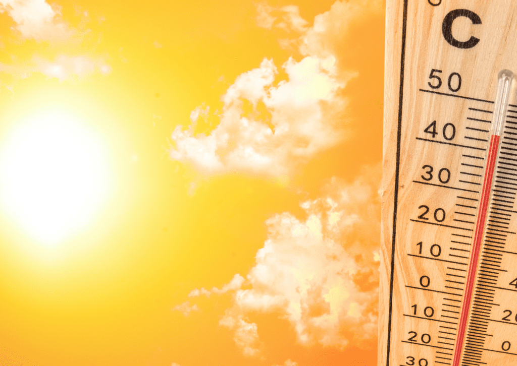 A thermometer with a sun in the background.