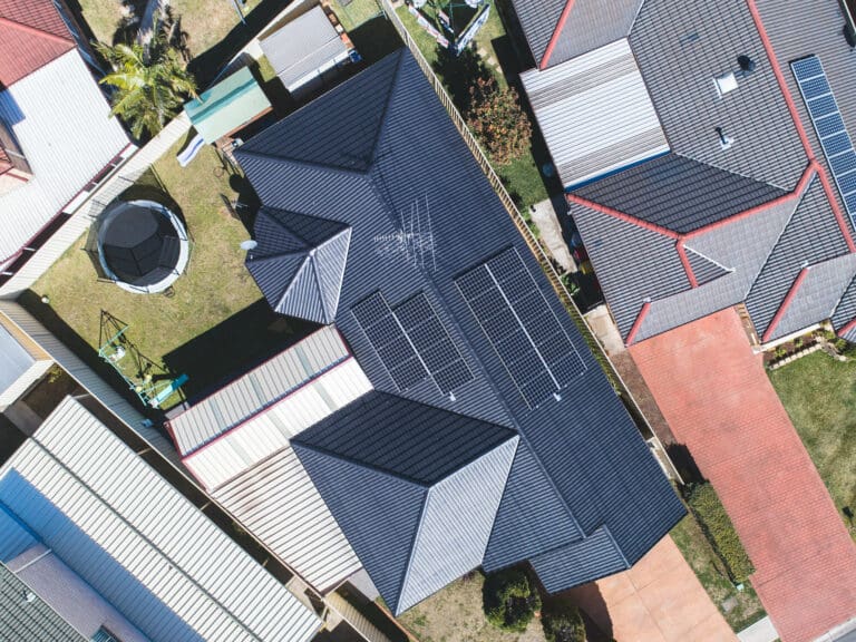 An aerial view of a house with solar panels.
