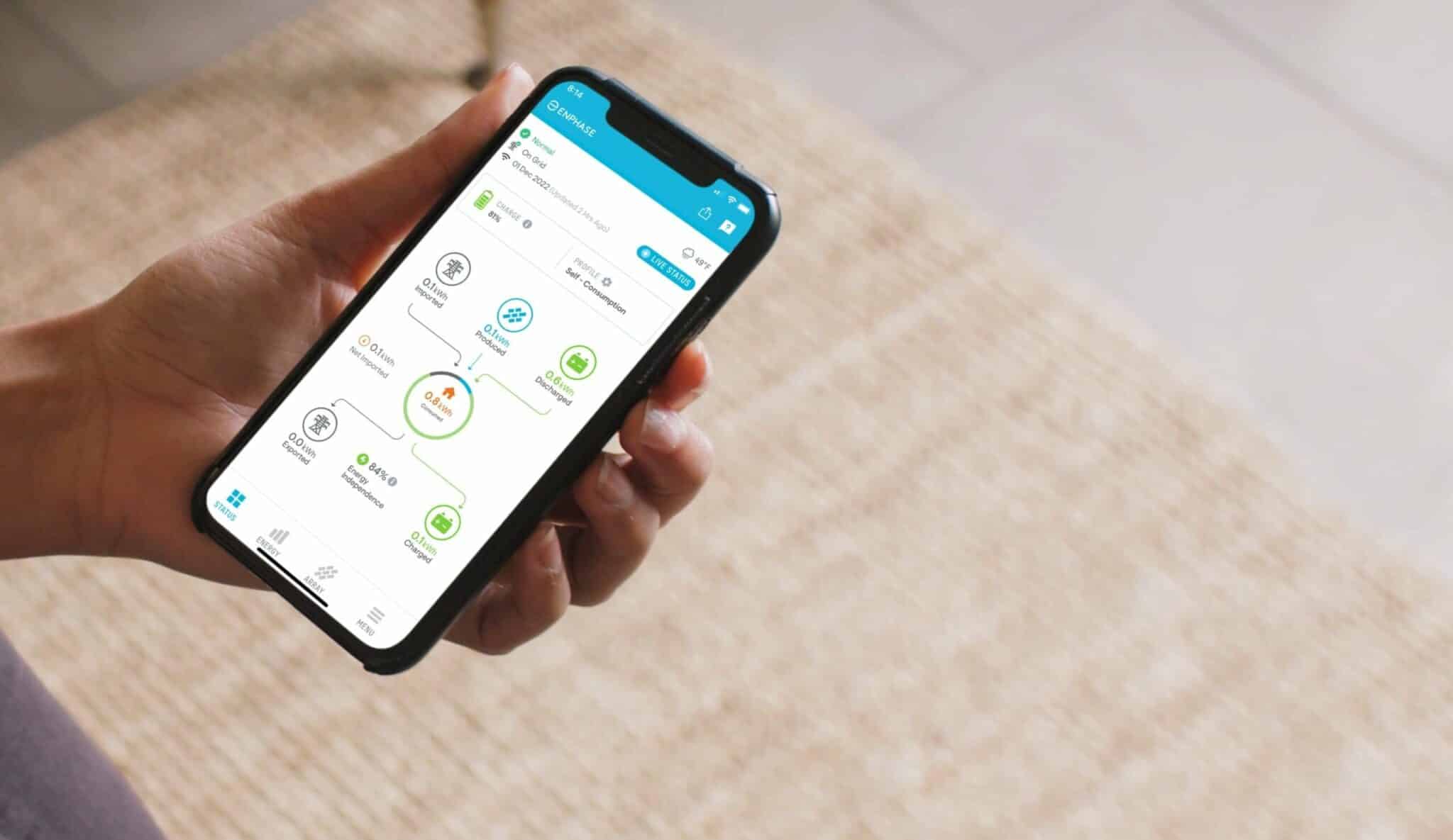 A person holding a phone with a smart home app on it.