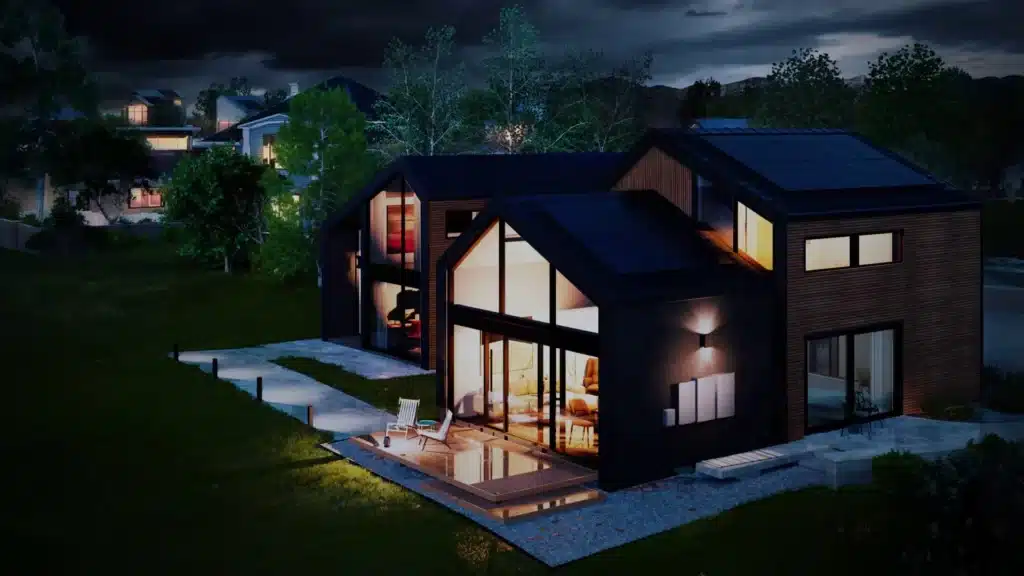 A house at night with a solar panel on the roof.