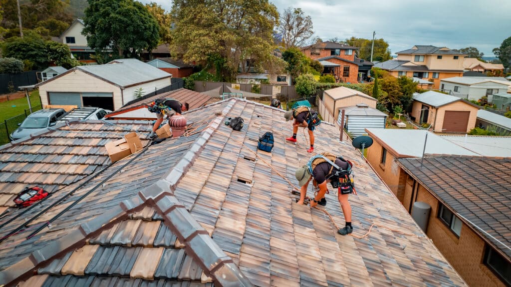A group of men working on a roof.