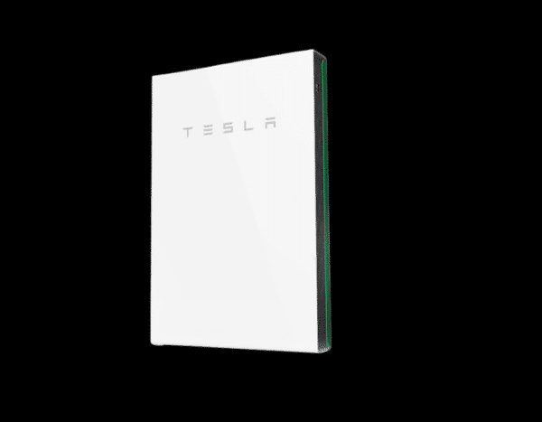 A tesla powerwall battery mounted on a wall with a black background.