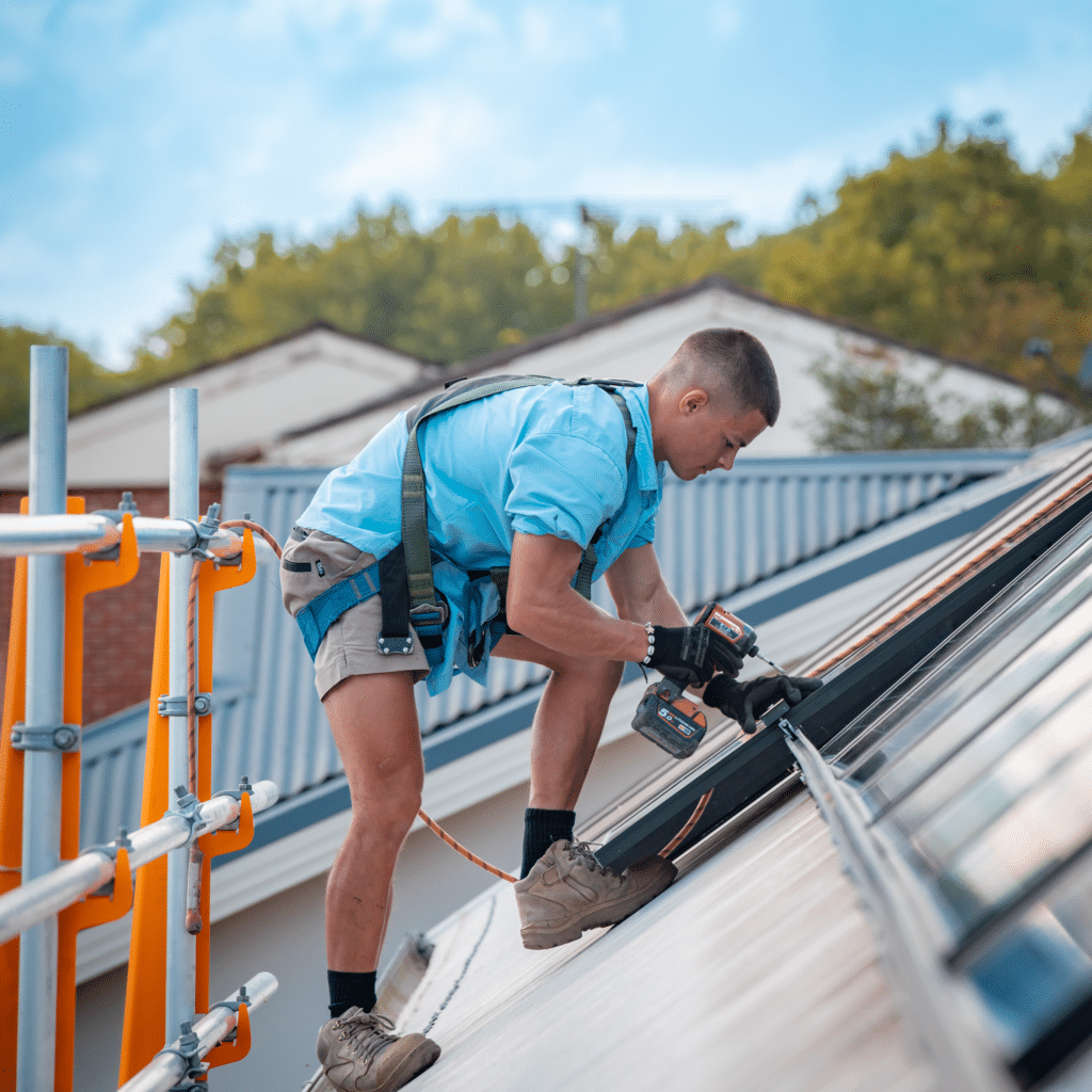 A man working on a roof with a ladder.