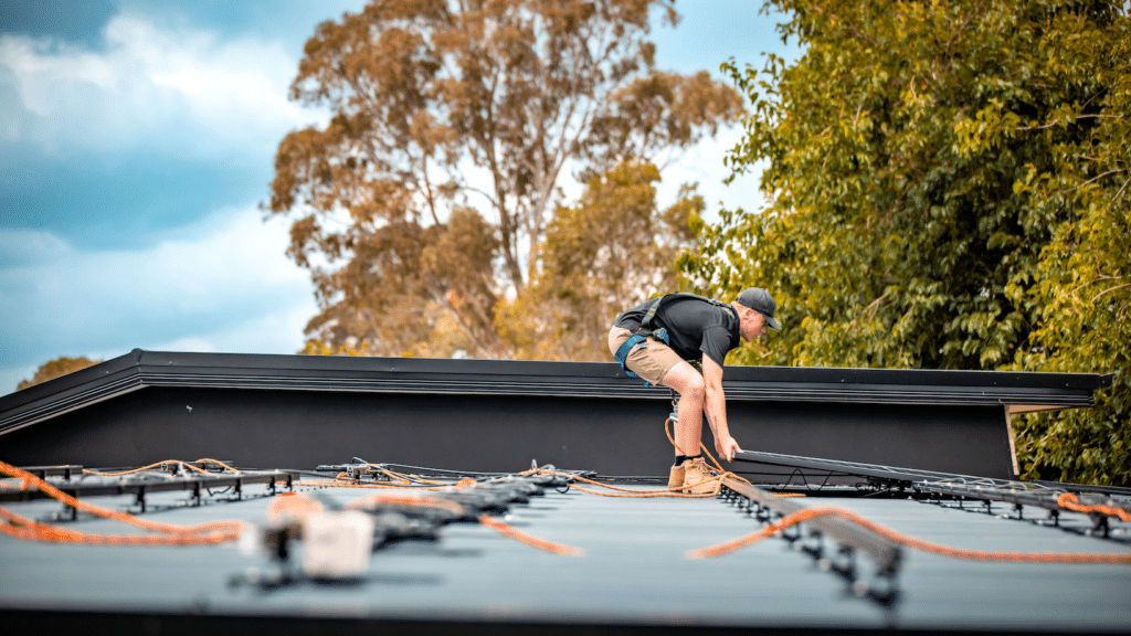 A man installing solar mounting system on a roof.